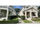 Exterior shot of townhomes with well manicured lawns and landscaping at 7110 Red Lantern Dr # 23, Harmony, FL 34773