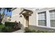 Charming front entrance with covered porch and neatly landscaped front yard at 7110 Red Lantern Dr # 23, Harmony, FL 34773