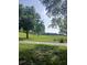 Expansive community green space with mature trees and landscaping at 7110 Red Lantern Dr # 23, Harmony, FL 34773