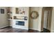 Cozy living room featuring a modern electric fireplace, built-in shelves, and elegant decor at 7110 Red Lantern Dr # 23, Harmony, FL 34773