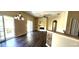 View of a sunlit living room with modern light fixtures and beautiful laminate flooring at 7110 Red Lantern Dr # 23, Harmony, FL 34773