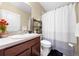 Bathroom featuring a vanity, toilet, shower with curtain, and neutral color palette at 739 Jefferson, Davenport, FL 33837