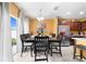 Open-concept dining area with natural light, adjacent stainless refrigerator, and dark wood table set for six at 739 Jefferson, Davenport, FL 33837