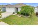 Well maintained lawn with charming landscaping including stepping stones, flowerpots, and solar lights at 739 Jefferson, Davenport, FL 33837