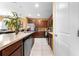 Spacious kitchen with stainless appliances, wood cabinets, island, and view to the dining area at 739 Jefferson, Davenport, FL 33837