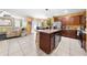 Open-concept kitchen with island and stainless steel appliances flowing into the living and dining areas at 739 Jefferson, Davenport, FL 33837