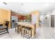 Bright kitchen with island seating, stainless steel appliances, and open floor plan to living spaces at 739 Jefferson, Davenport, FL 33837
