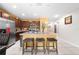 Kitchen featuring an island with seating, stainless steel appliances, and open layout to living spaces at 739 Jefferson, Davenport, FL 33837