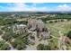 Panoramic aerial view of a resort featuring lush landscaping, a golf course, and multiple buildings at 7458 Gathering Dr, Kissimmee, FL 34747