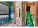 Bathroom with shower-tub combo adjacent to a door and slide, blending convenience with a playful at 7458 Gathering Dr, Kissimmee, FL 34747