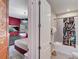 View from the hallway of the bedroom and bathroom that features a tub with a floral curtain at 7458 Gathering Dr, Kissimmee, FL 34747
