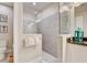 Bathroom featuring walk-in shower, tiled floor, and decorative accents at 7458 Gathering Dr, Kissimmee, FL 34747