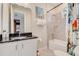 Bathroom featuring shower and tub combo, vanity, and colorful shower curtain at 7458 Gathering Dr, Kissimmee, FL 34747