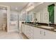 Elegant bathroom featuring dual sinks, granite countertops, and a glass-enclosed shower at 7458 Gathering Dr, Kissimmee, FL 34747