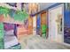 View of a bedroom with lofted custom bunk beds, custom floral ceiling accents, and a connecting hallway at 7458 Gathering Dr, Kissimmee, FL 34747
