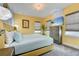 Bright bedroom with a king bed, large dresser with television, and decorated with unique light fixtures and wall art at 7458 Gathering Dr, Kissimmee, FL 34747