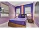 Bedroom featuring stylish decor, two windows, and accent lighting at 7458 Gathering Dr, Kissimmee, FL 34747