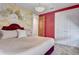 Bedroom featuring elegant gold accents, a decorative chandelier, and an en suite bathroom at 7458 Gathering Dr, Kissimmee, FL 34747