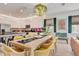 Bright dining area connected to a modern kitchen featuring a breakfast bar and stainless appliances at 7458 Gathering Dr, Kissimmee, FL 34747