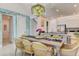 Charming dining room with stylish light fixture, seating for eight, and easy access to the kitchen and living areas at 7458 Gathering Dr, Kissimmee, FL 34747