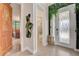 Bright entryway with decorative door and leafy decor and views to bathroom and bedroom at 7458 Gathering Dr, Kissimmee, FL 34747