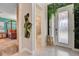Bright entryway with decorative door and leafy decor and views to bathroom and bedroom at 7458 Gathering Dr, Kissimmee, FL 34747
