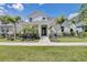 Stunning two-story home with lush landscaping and inviting entrance in a tropical setting at 7458 Gathering Dr, Kissimmee, FL 34747