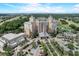 Grand exterior view of a luxury resort, surrounded by palm trees, a golf course, and manicured landscaping at 7458 Gathering Dr, Kissimmee, FL 34747
