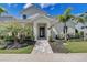 Inviting single-story home exterior showcasing a well-manicured front yard and paved walkway at 7458 Gathering Dr, Kissimmee, FL 34747