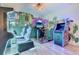Fun game room with arcade games and vibrant wall murals for Gathering entertainment at 7458 Gathering Dr, Kissimmee, FL 34747