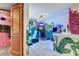 Fun-themed game room featuring multiple arcade games and colorful wall murals with door at 7458 Gathering Dr, Kissimmee, FL 34747