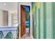 Hallway leading to a themed room, featuring unique wall art and an inviting atmosphere at 7458 Gathering Dr, Kissimmee, FL 34747