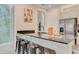 Elegant kitchen featuring a dark countertop, stainless steel appliances, and barstool seating for casual dining at 7458 Gathering Dr, Kissimmee, FL 34747