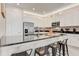 Modern kitchen with white cabinetry, stainless steel appliances, and a dark countertop for a sleek look at 7458 Gathering Dr, Kissimmee, FL 34747