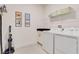 Laundry room with washer, dryer, cabinet space, and tile flooring at 7458 Gathering Dr, Kissimmee, FL 34747