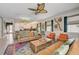 Bright and open living area with modern furnishings, colorful rug, and large windows offering natural light at 7458 Gathering Dr, Kissimmee, FL 34747
