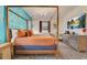 Bedroom with four-poster bed, butterfly wall decor, and stylish furnishings at 7458 Gathering Dr, Kissimmee, FL 34747