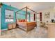 Bedroom with four-poster bed, butterfly wall decor, and stylish furnishings at 7458 Gathering Dr, Kissimmee, FL 34747