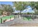 A delightful mini-golf course with green turf and surrounded by gravel, trees, and decorative rock features at 7458 Gathering Dr, Kissimmee, FL 34747