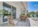 Outdoor patio area with comfortable seating and a view of the pool area and landscaping at 7458 Gathering Dr, Kissimmee, FL 34747