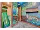 Creative playroom with a slide, themed murals, and a TV for fun and entertainment at 7458 Gathering Dr, Kissimmee, FL 34747