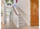 Elegant staircase with decorative accents, including a character-themed door and floral arrangements at 7458 Gathering Dr, Kissimmee, FL 34747