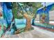 Themed bedroom with a detailed treehouse, murals, and ambient lighting for magical experience at 7458 Gathering Dr, Kissimmee, FL 34747
