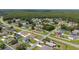 Neighborhood aerial view showing many houses surrounded by dense trees and lush green lawns at 761 Parrot Ct, Kissimmee, FL 34759