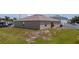 Exterior view of home with backyard and sliding glass doors at 761 Parrot Ct, Kissimmee, FL 34759