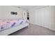 Bright bedroom features plush gray carpeting and double door closet for storage at 761 Parrot Ct, Kissimmee, FL 34759