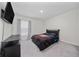 This bedroom features a modern design with carpet and a flat screen television at 761 Parrot Ct, Kissimmee, FL 34759