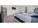 Bedroom with plush carpeting, ensuite bathroom, and living space access at 761 Parrot Ct, Kissimmee, FL 34759