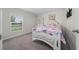 Cozy bedroom featuring soft carpet, ample light, and cute, stylish decor at 761 Parrot Ct, Kissimmee, FL 34759