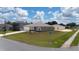 Corner lot featuring a well-manicured lawn with an attached two-car garage at 761 Parrot Ct, Kissimmee, FL 34759